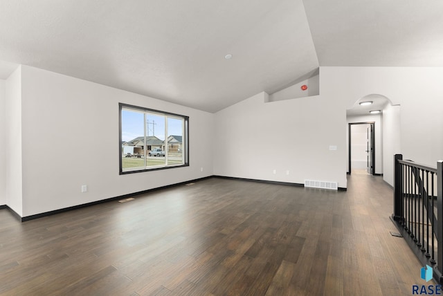 unfurnished room with dark hardwood / wood-style floors and vaulted ceiling