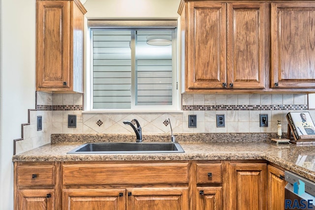 kitchen with dishwasher, sink, and tasteful backsplash