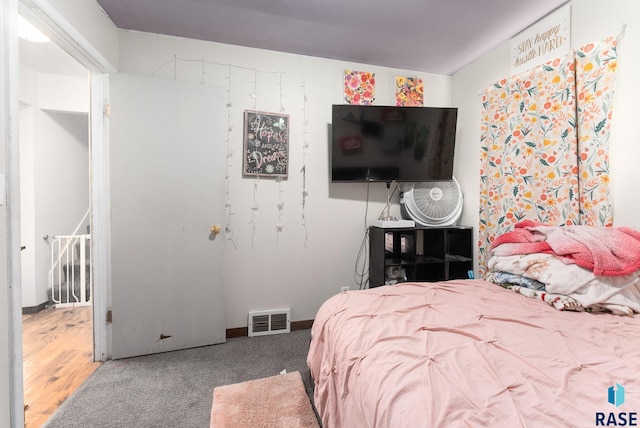 bedroom with hardwood / wood-style floors