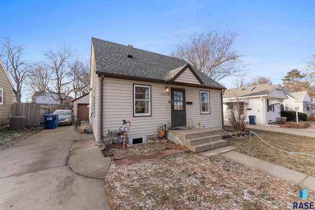 bungalow-style house featuring central AC and a garage