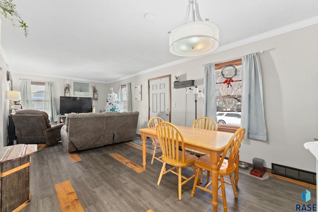 dining area with dark hardwood / wood-style floors and ornamental molding