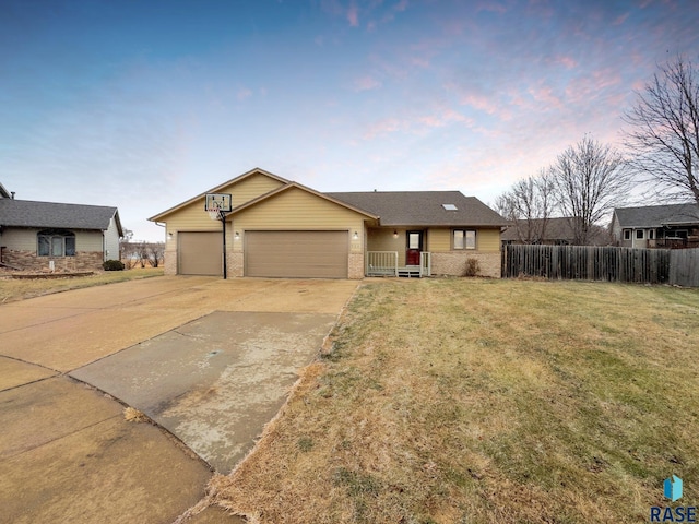 single story home with a lawn and a garage