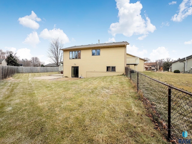 rear view of house featuring a lawn and a patio area