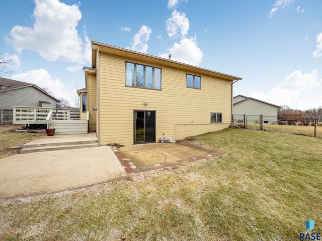 back of property with a lawn and a patio area