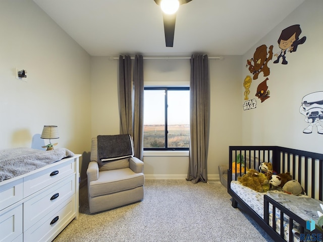 bedroom with a crib and light colored carpet