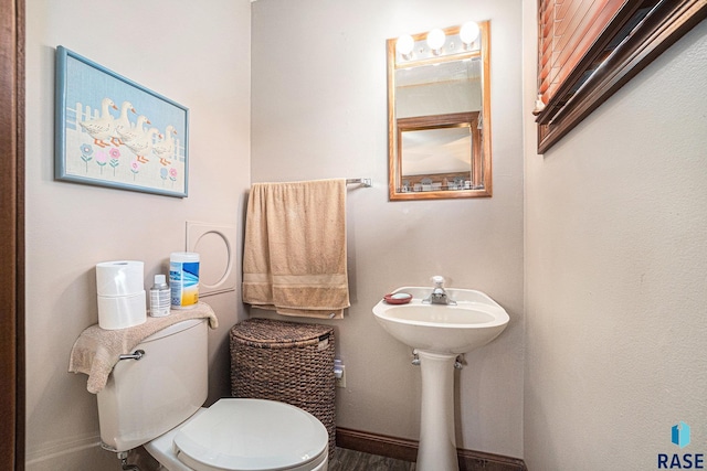 bathroom featuring hardwood / wood-style floors and toilet