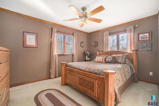 carpeted bedroom with ceiling fan and ornamental molding