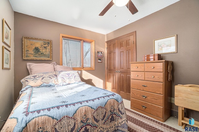 bedroom featuring a closet, ceiling fan, and light colored carpet