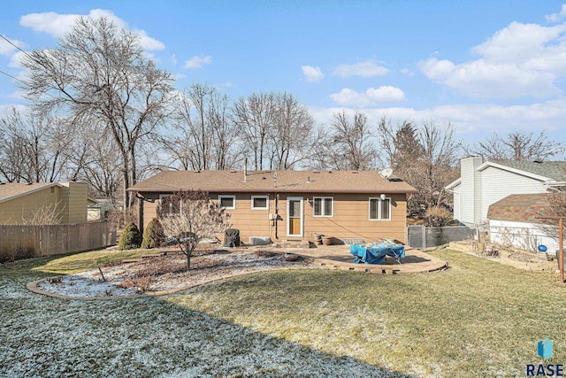 rear view of property with a lawn