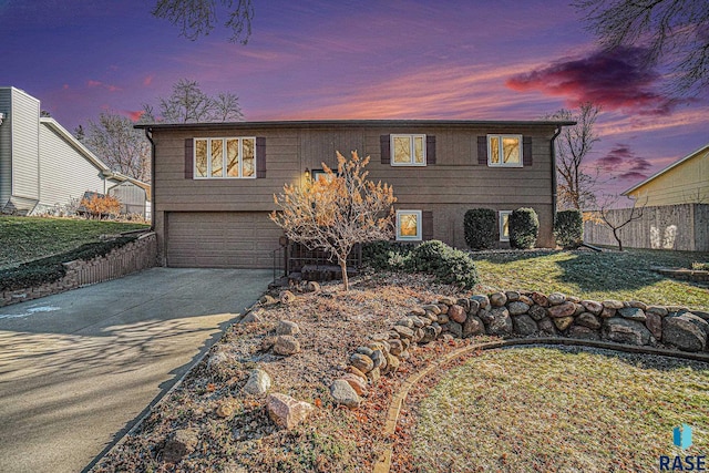 view of front of house featuring a yard and a garage