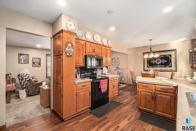 kitchen featuring electric range, dark hardwood / wood-style flooring, a chandelier, pendant lighting, and decorative backsplash