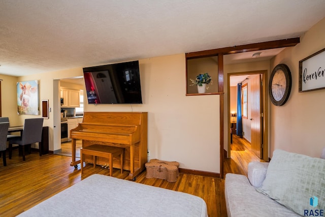 interior space featuring hardwood / wood-style flooring and a textured ceiling