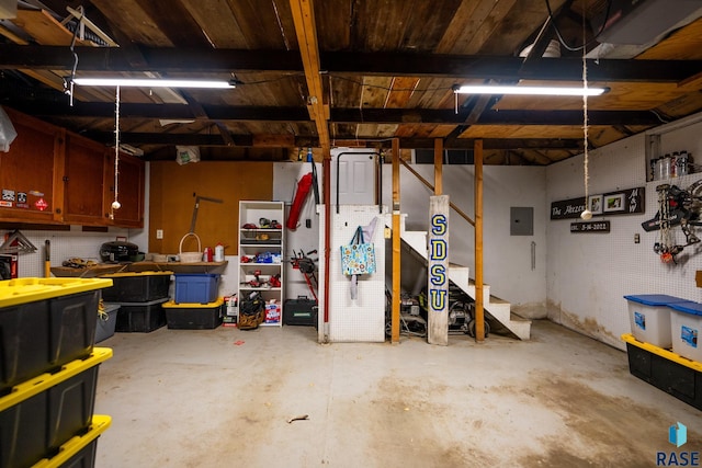 garage with a workshop area and electric panel