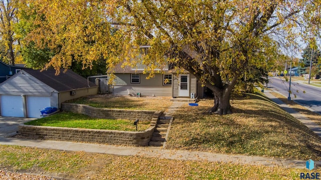 view of property hidden behind natural elements with a garage