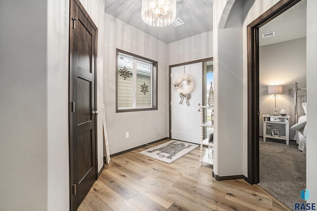 entryway with a notable chandelier and light hardwood / wood-style flooring