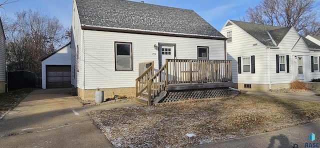 view of front of house featuring a garage, an outdoor structure, and a wooden deck