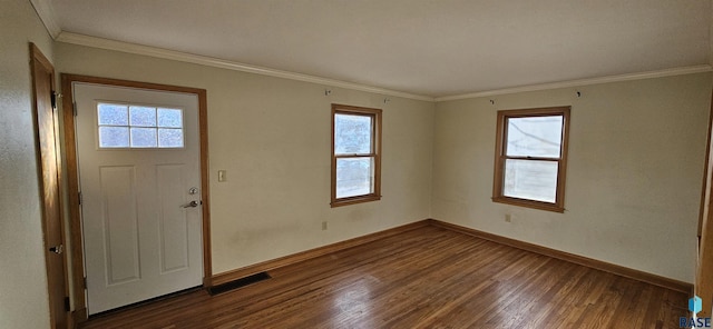 foyer with dark hardwood / wood-style floors, crown molding, and a wealth of natural light