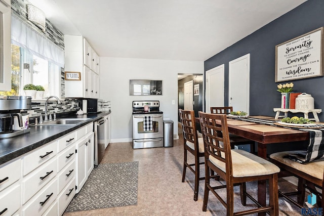 kitchen featuring white cabinets, sink, appliances with stainless steel finishes, and tasteful backsplash