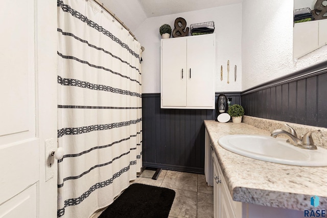 bathroom featuring tile patterned flooring and vanity