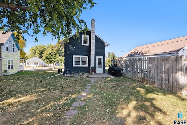 back of house featuring a yard