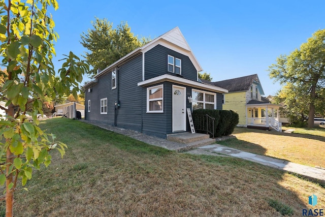 view of front of property with covered porch and a front lawn