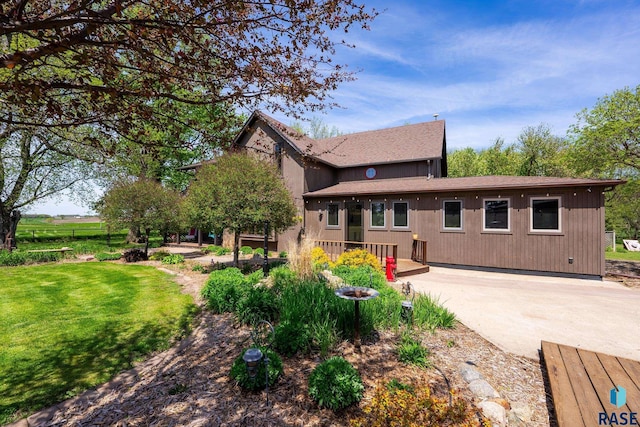 exterior space with a wooden deck and a lawn