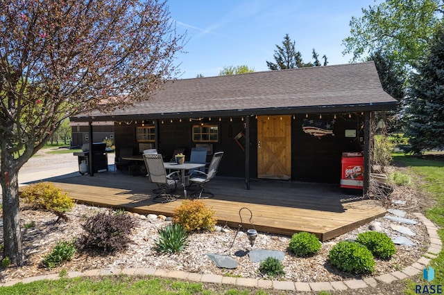 back of property with a wooden deck