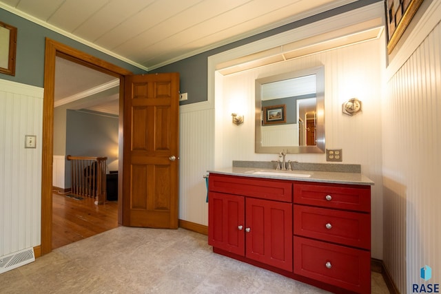 bathroom featuring hardwood / wood-style floors, vanity, and ornamental molding