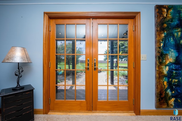 doorway with french doors and light colored carpet