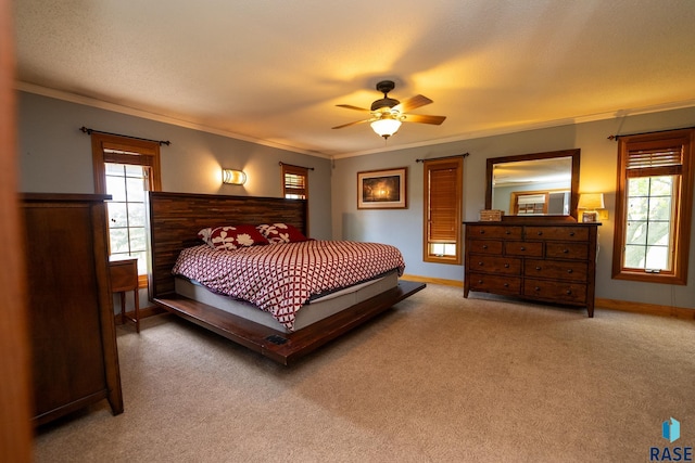 carpeted bedroom featuring multiple windows, ceiling fan, and ornamental molding