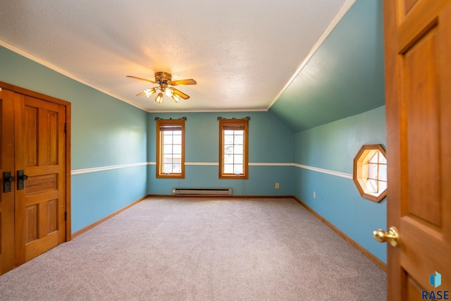 additional living space with light carpet, ceiling fan, a baseboard radiator, and a textured ceiling