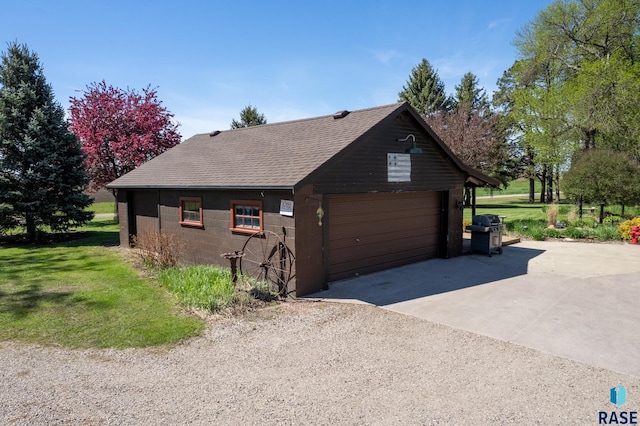 view of home's exterior with a yard, an outbuilding, and a garage