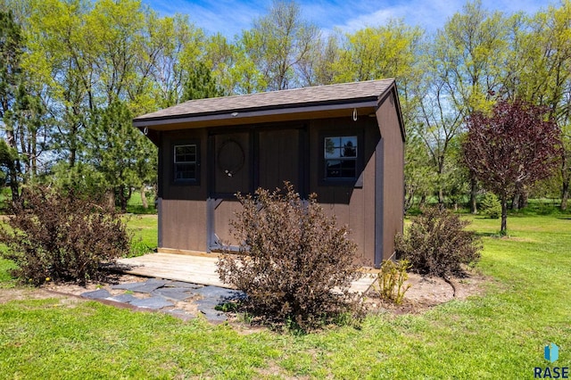 view of outbuilding featuring a lawn