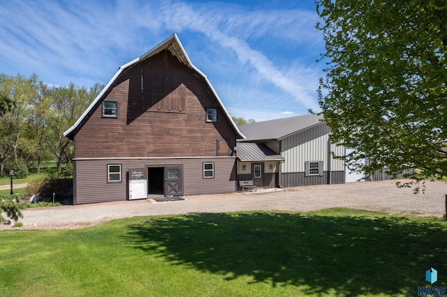 rear view of house with a yard and an outbuilding