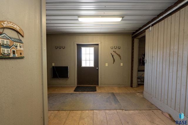 entryway featuring wood walls and light hardwood / wood-style floors