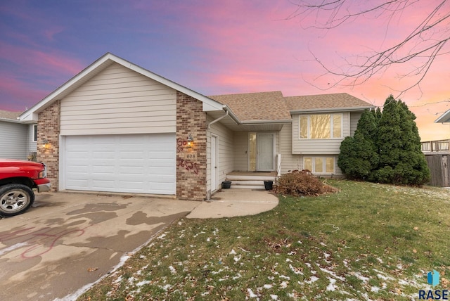 view of front of property with a lawn and a garage