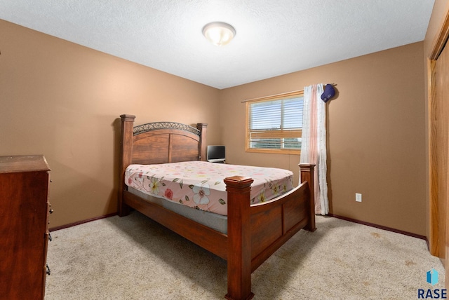 carpeted bedroom featuring a textured ceiling