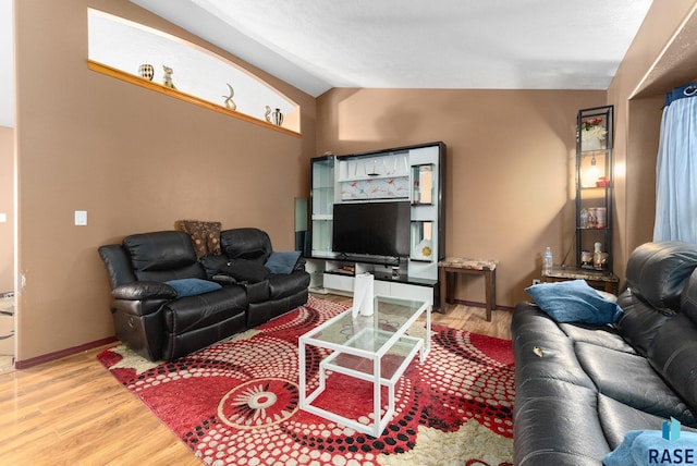 living room with lofted ceiling and hardwood / wood-style flooring