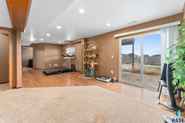 workout room featuring light wood-type flooring