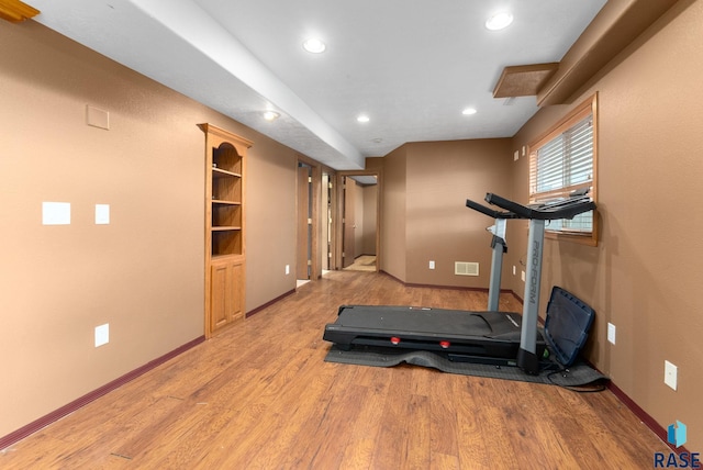 workout area featuring light wood-type flooring