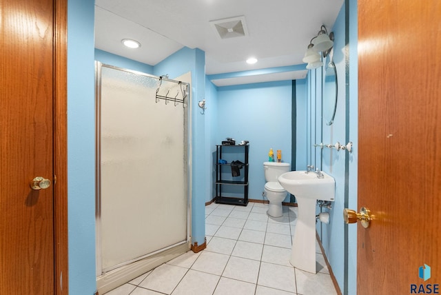 bathroom with tile patterned floors, toilet, an enclosed shower, and sink