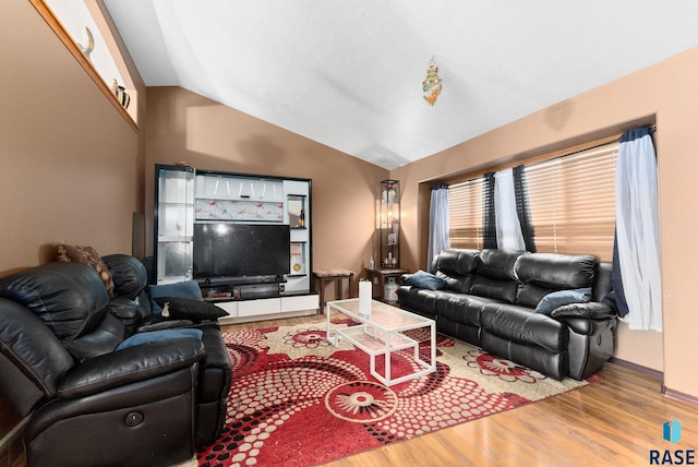 living room featuring hardwood / wood-style floors and vaulted ceiling