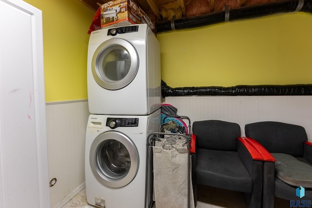 laundry area with stacked washing maching and dryer