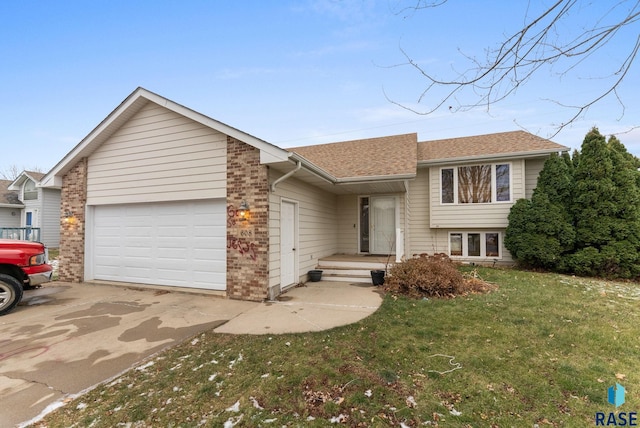 view of front of home with a front yard and a garage