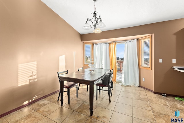 dining space with a notable chandelier and lofted ceiling