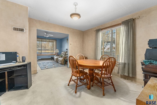 dining room featuring ceiling fan and carpet