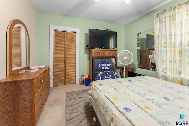 bedroom with light carpet and a closet