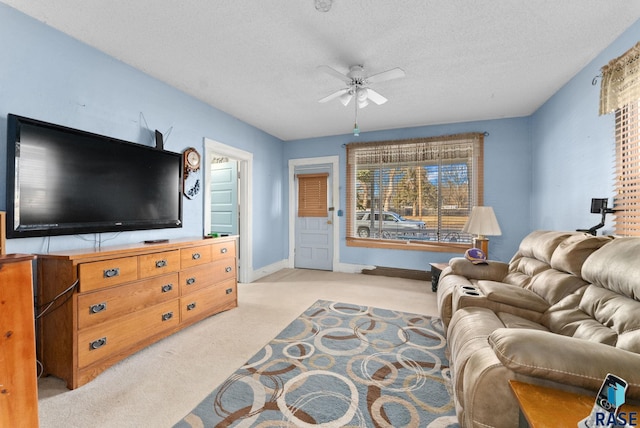 carpeted living room with a textured ceiling and ceiling fan