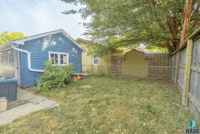 view of yard with a storage unit and central air condition unit