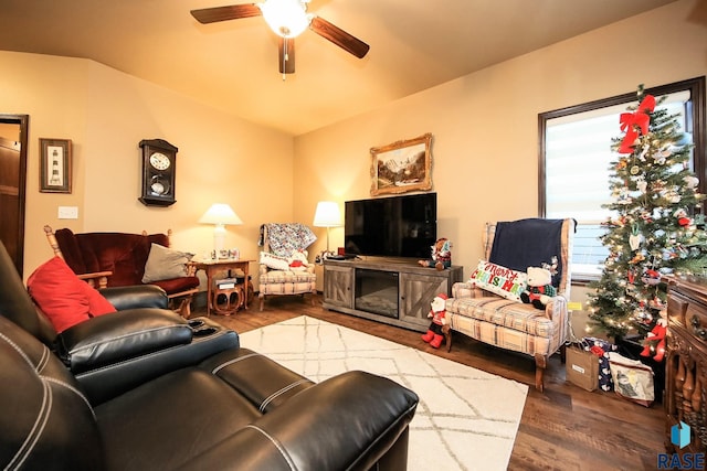 living room with hardwood / wood-style flooring, ceiling fan, and a fireplace